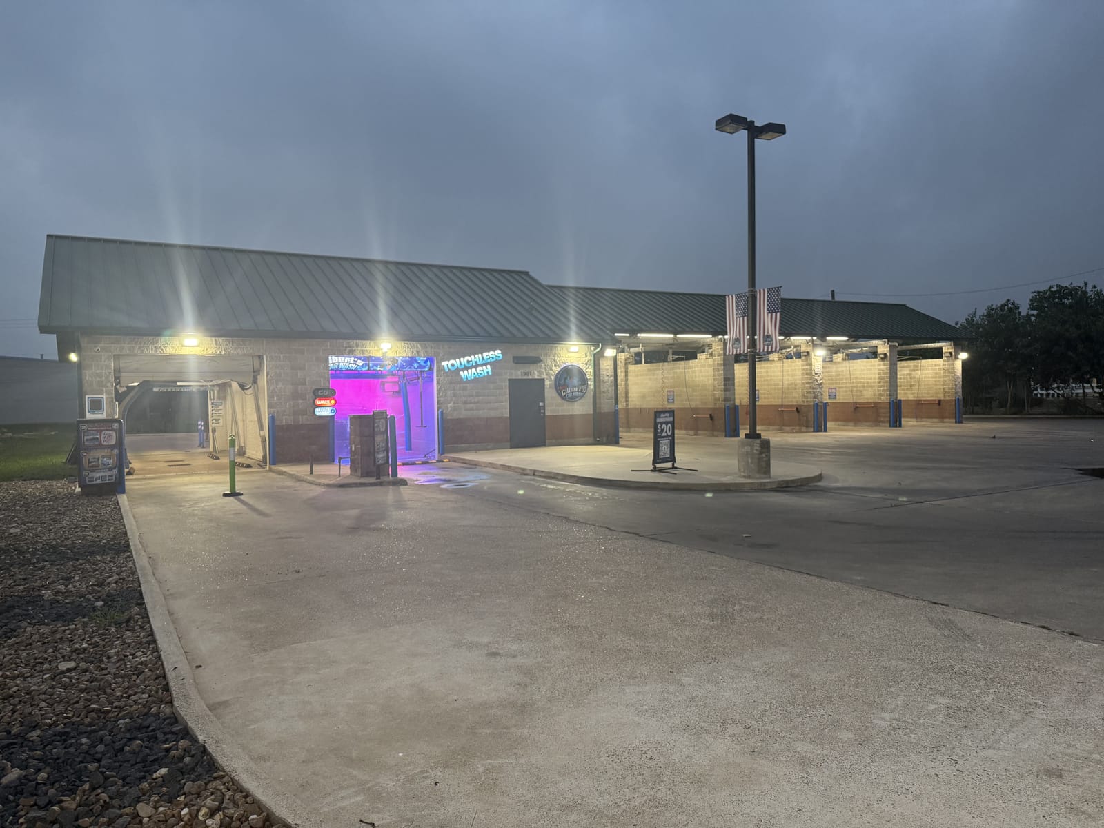 Gilbert's Car Wash Victoria lit up at night.