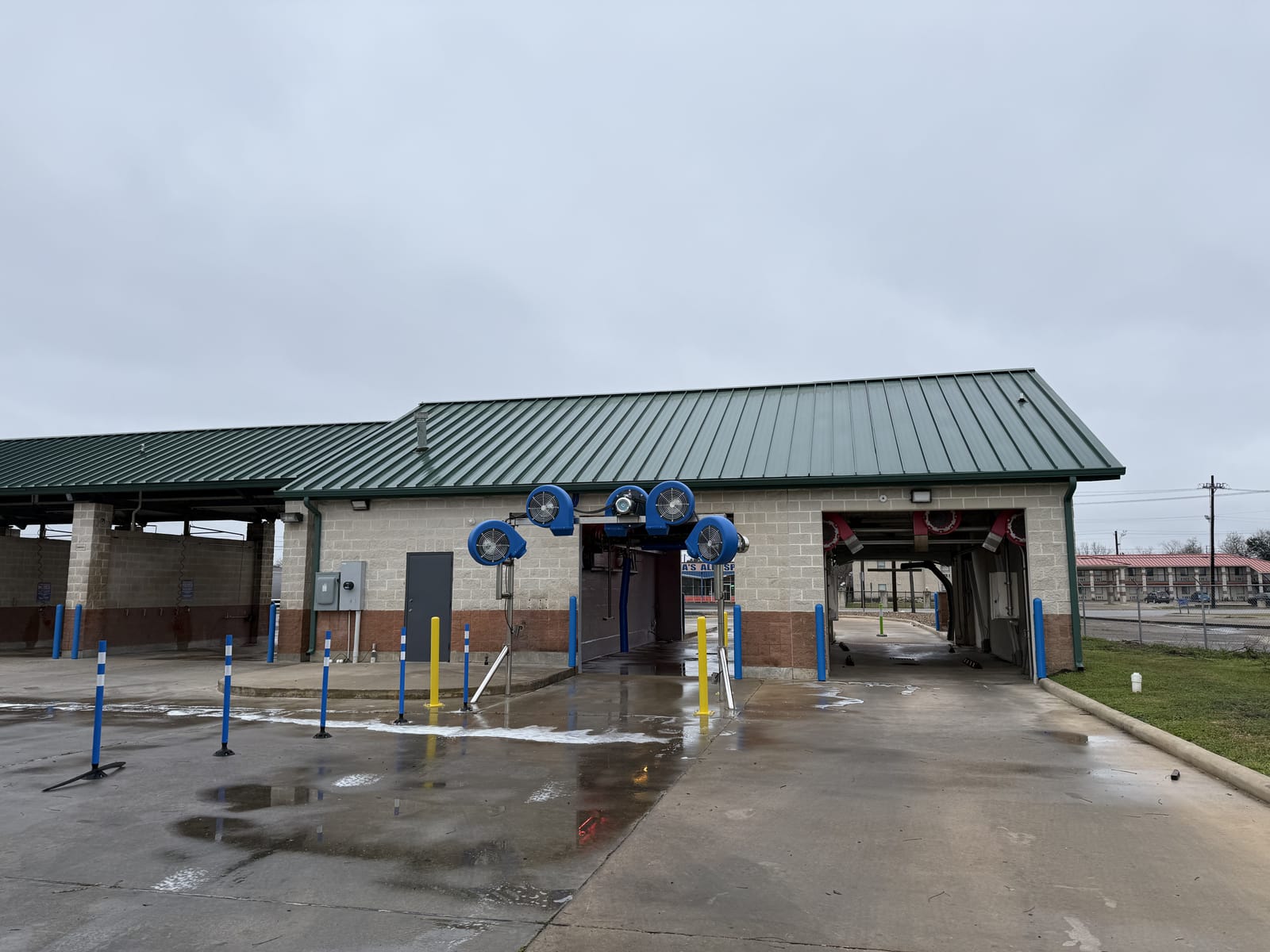 A vehicle moving through the touchless automatic wash at Gilbert's Car Wash Victoria.