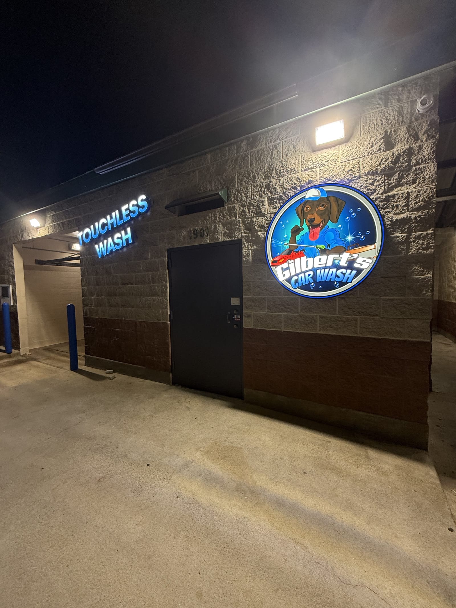 Illuminated touchless automatic wash sign at Gilbert's Car Wash Victoria at night.